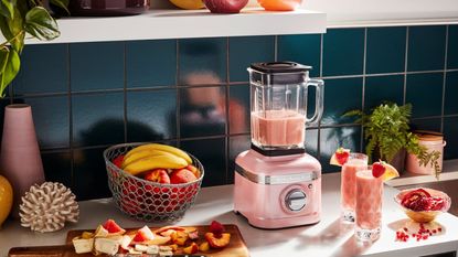 A kitchen with pink kitchen appliances, pink cabinets and pink plates