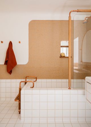 a bathroom with an orange and white tile and grout color scheme
