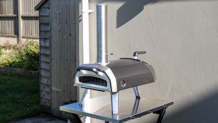 Ooni Karu 2 pizza oven outdoors on a table