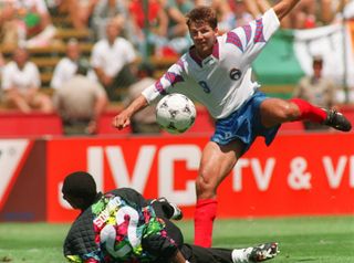 Russia's Oleg Salenko scores past Cameroon goalkeeper Jacques Songo'o to net his fifth goal of the game in a 6-1 win at the 1994 World Cup.