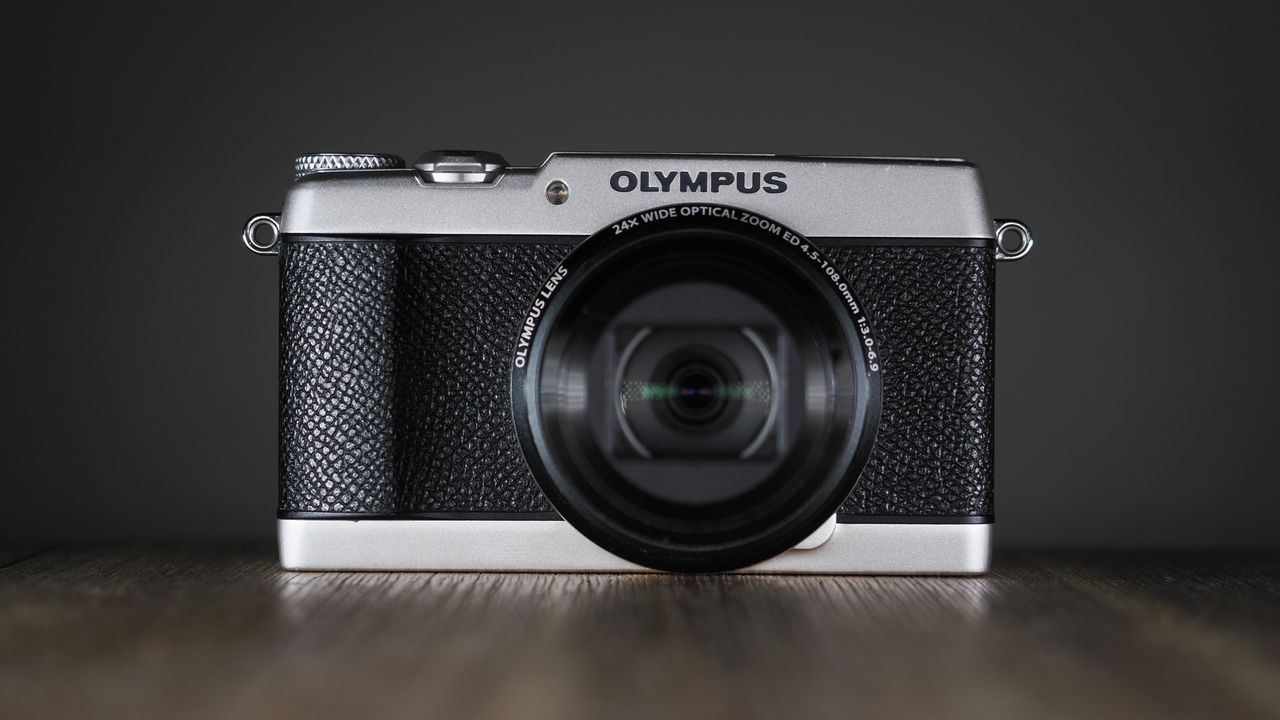 Olympus Stylus SH-3 on a wooden surface