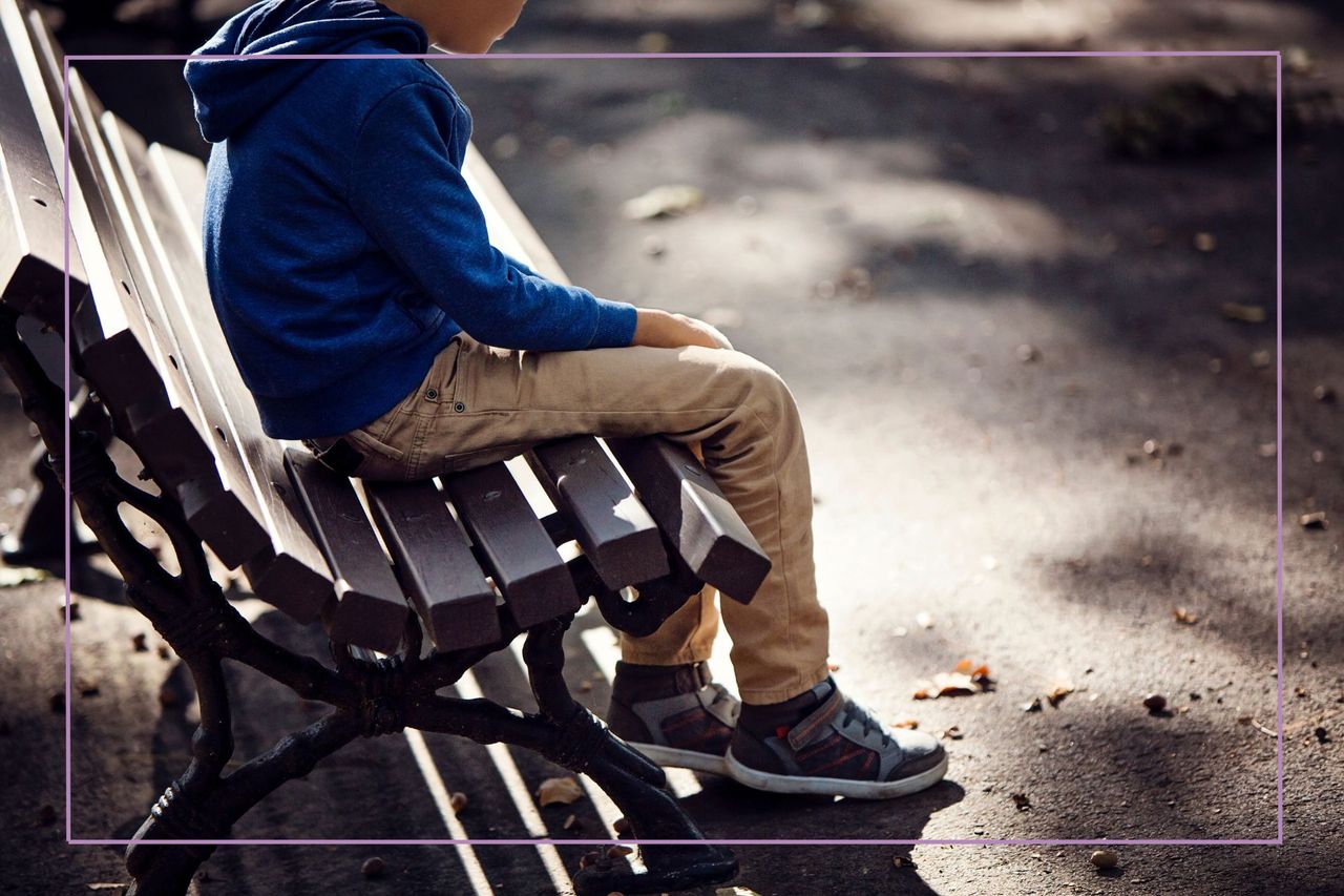 neglectful parenting illustrated by child sat on own on bench