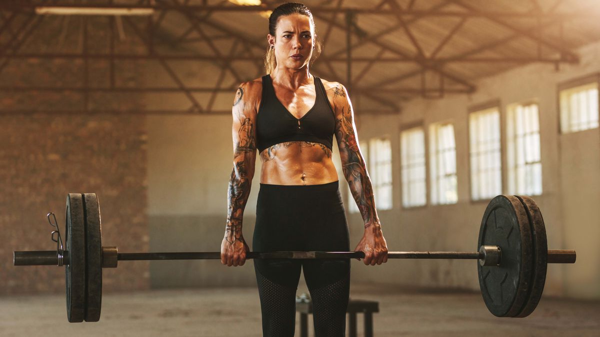 a photo of a woman holding a barbell