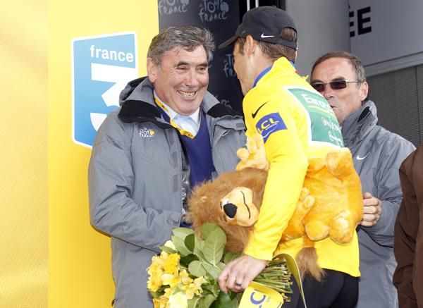 Thomas Voeckler is congratulated on his 20th yellow jersey of his career by Eddy Merckx.