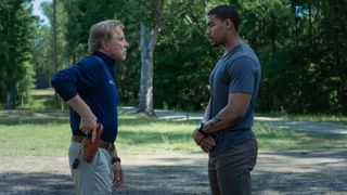 Sandy and Terry stare each other down in a street in Rebel Ridge, one of September's new Netflix movies