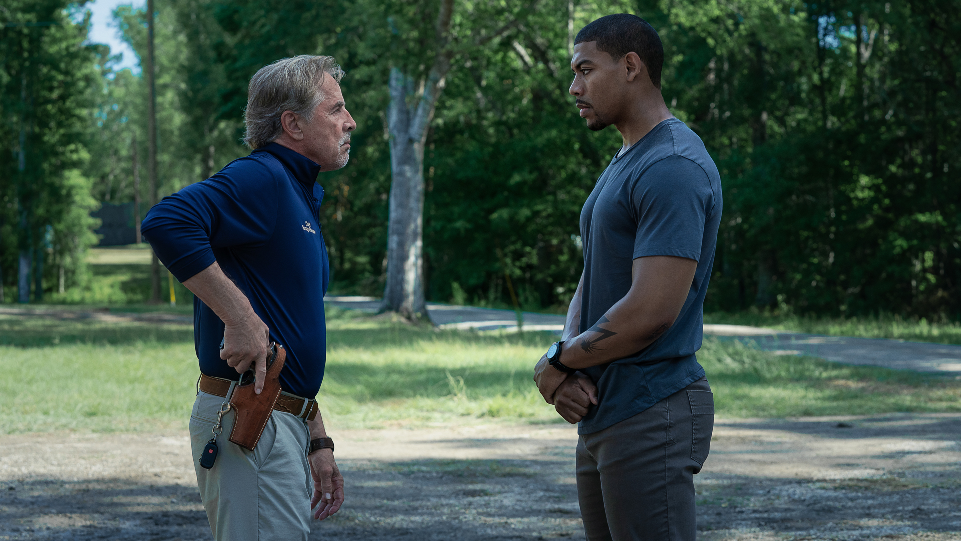 Sandy and Terry stare each other down in a street in Rebel Ridge