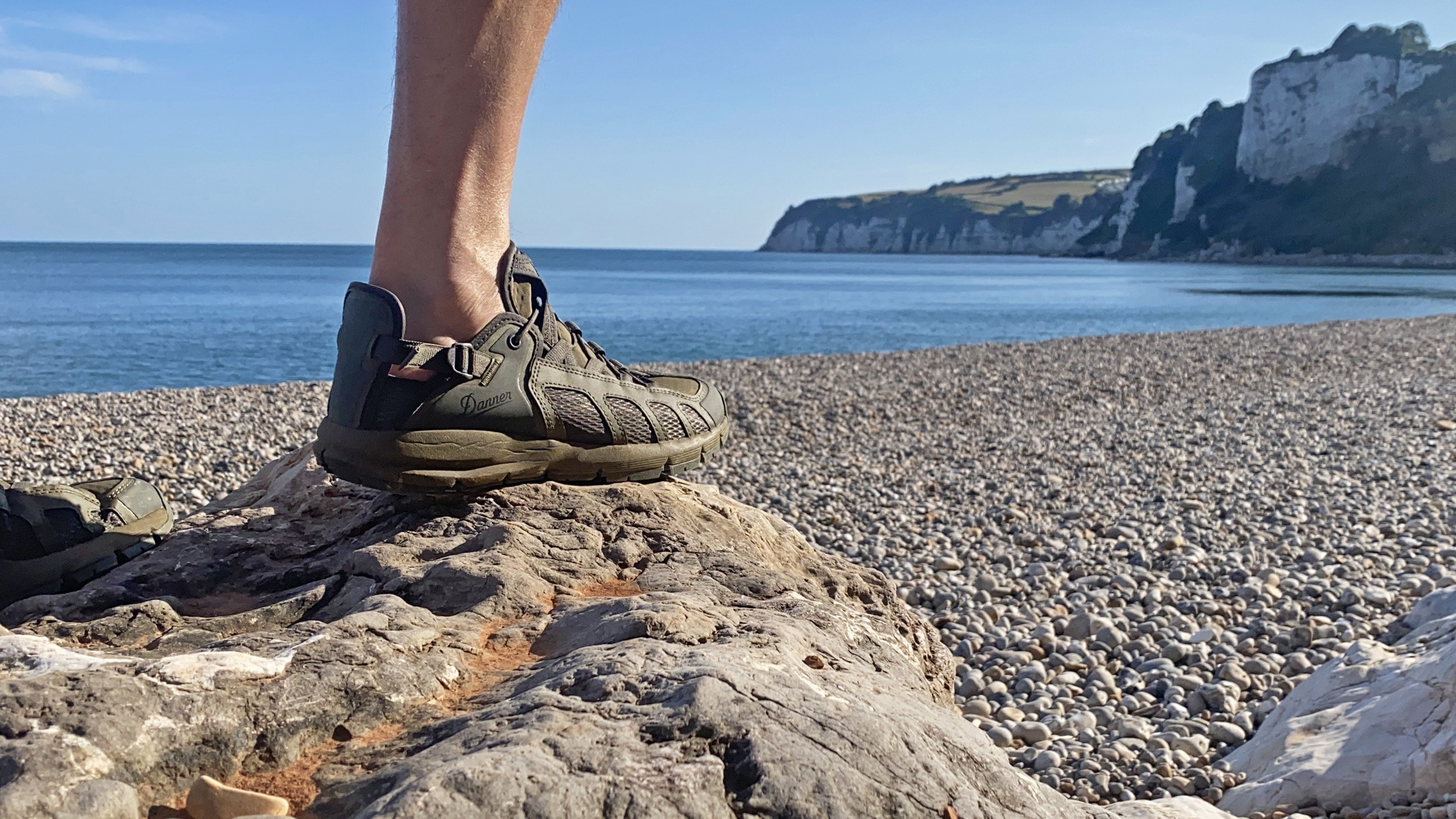 Hiker wearing Danner Fullbore sandals on a beach