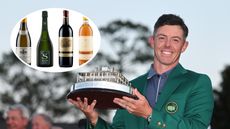 Rory McIlroy holds The Masters trophy in his green jacket and an inset of four wine bottles