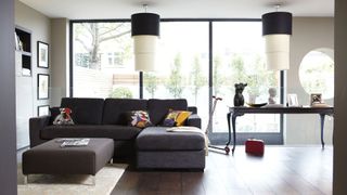Living room with a sofa, table and glass walls