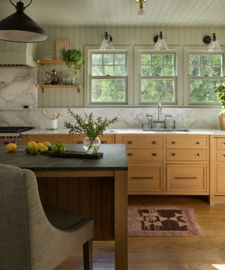 timeless interior design styles, kitchen with many textures, marble, countertops/splashbacks, shiplap walls and ceiling, wooden cabinetry, island with bar stools, lighting ideas