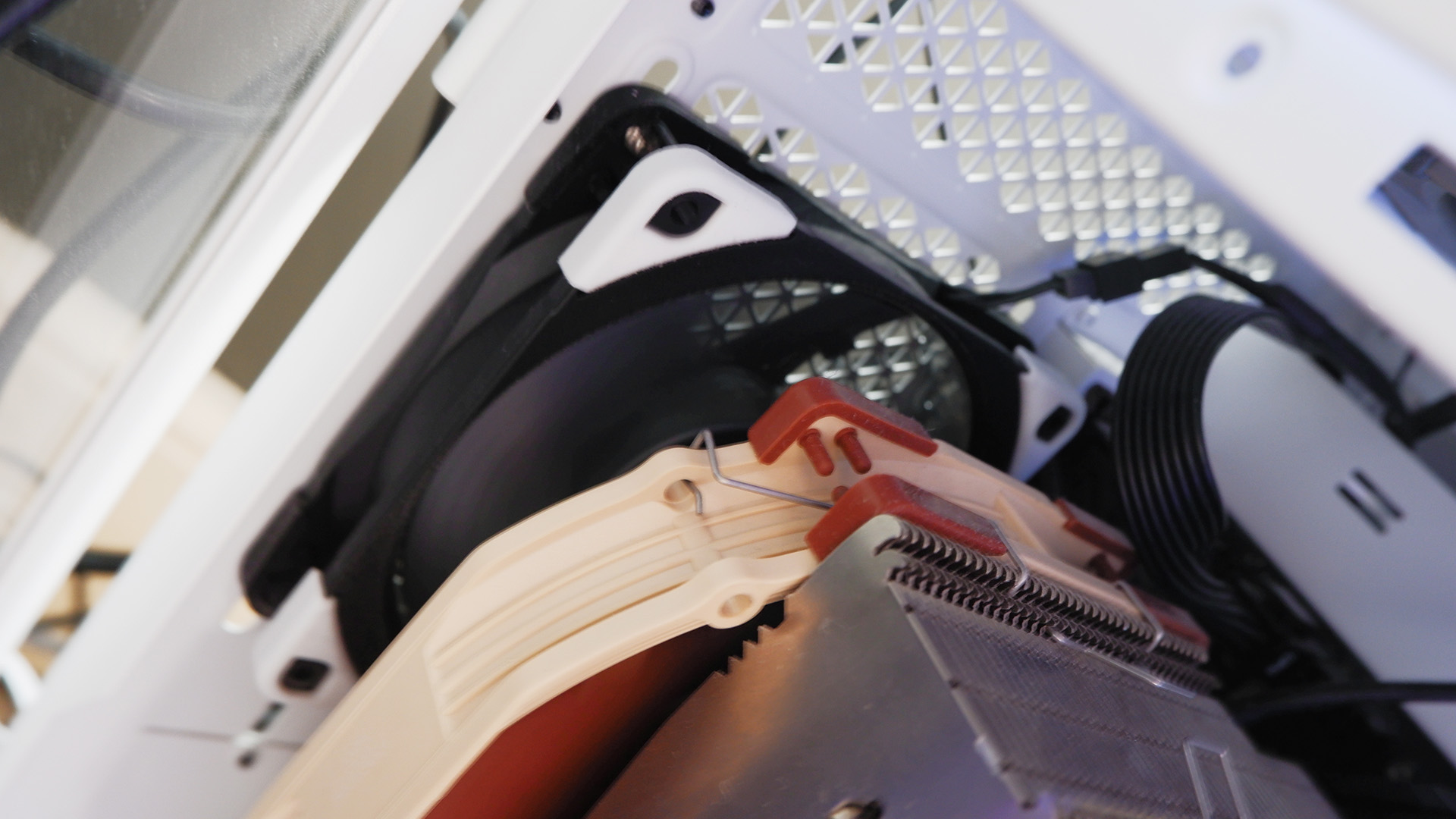 Noctua fans sitting on a desk with boxes.