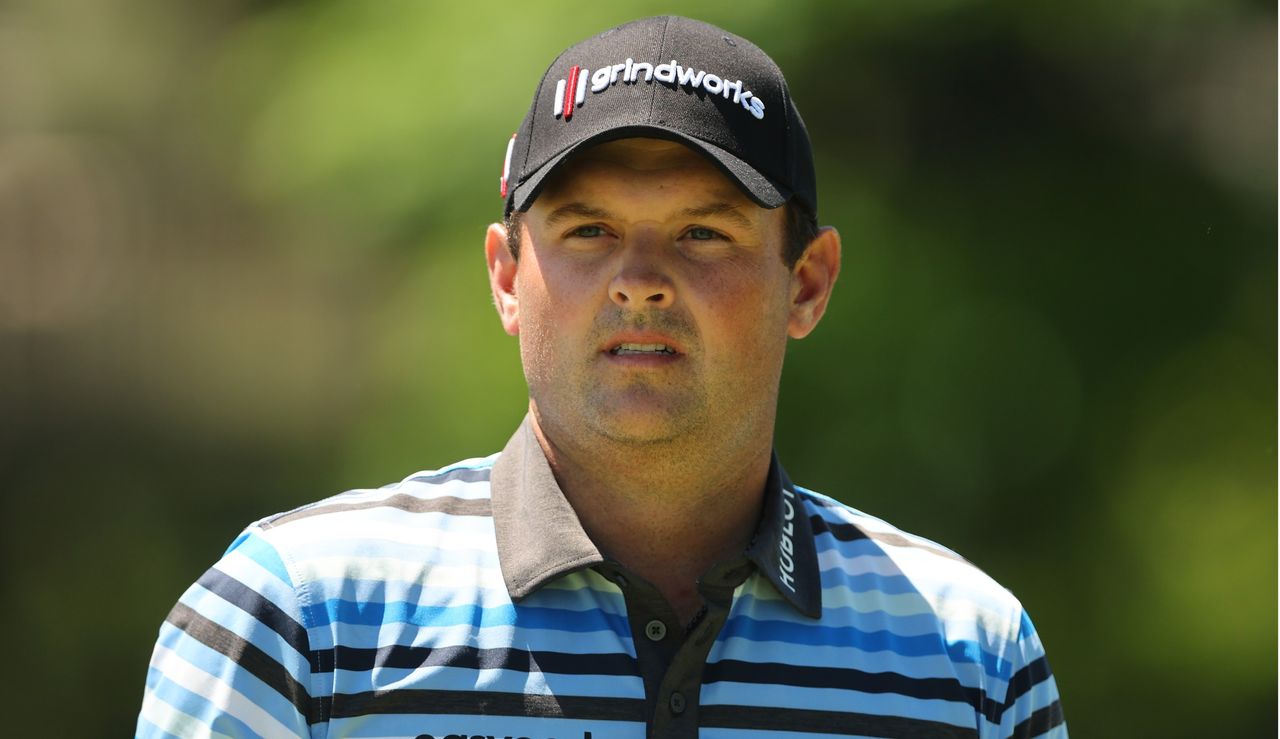 Reed looks on after hitting his tee shot