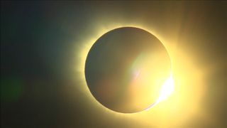 The sun peaks out from behind the moon just after totality during the total solar eclipse of March 20, 2015 as seen from the Norwegian Svalbard archipelago in this view webcast live by Norway's NRK News.