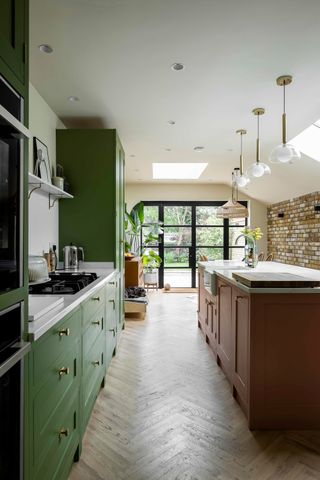 a green and brown kitchen in a modern extension