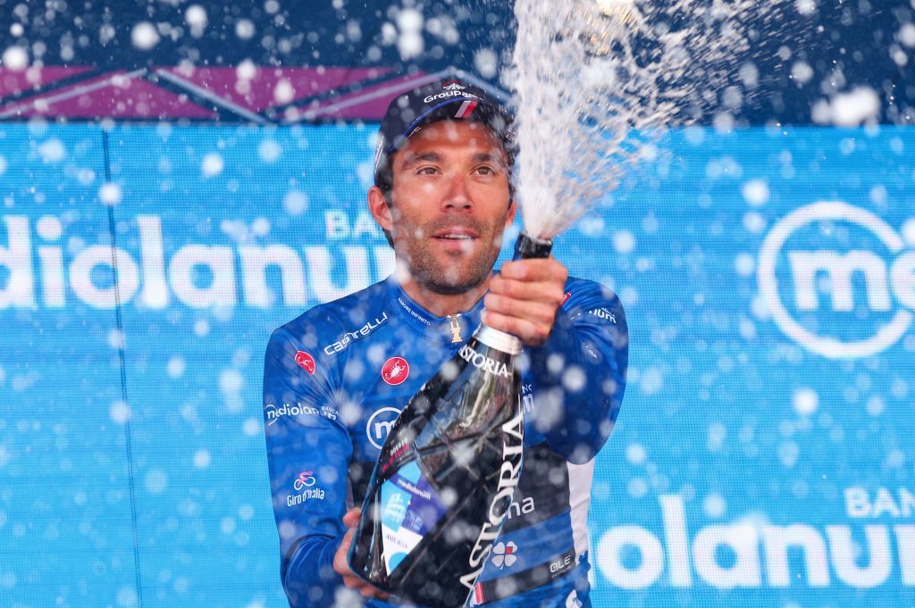 Groupama FDJs French rider Thibaut Pinot celebrates on the podium his best climbers blue jersey after the eighteenth stage of the Giro dItalia 2023 cycling race 161 km between Oderzo and Val di Zoldo on May 25 2023 Photo by Luca Bettini AFP Photo by LUCA BETTINIAFP via Getty Images