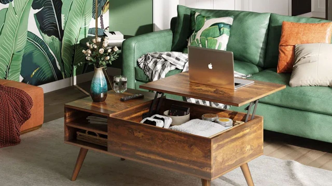 Grossi Coffee Table by George Oliver in a rustic oak finish inside a green living room with a green sofa, green plant wallpaper and a neutral rug