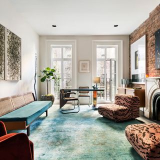this second living spaces is a mix of bold teal and abstract animal print fabric