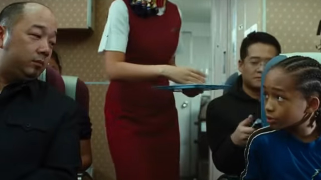 Jaden Smith talking to a fellow passenger on a plane in The Karate Kid