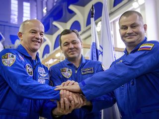 American astronaut Jeff Williams and Russian cosmonauts Oleg Skripochka and Alexei Ovchinin launched to the International Space Station March 18 from the Baikonur Cosmodrome in Kazakhstan. Here, they posed before their Soyuz qualification exams Feb. 24.