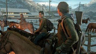 Ellie and Dina ride through a snowy field, with cattle fencing and some horses in the background