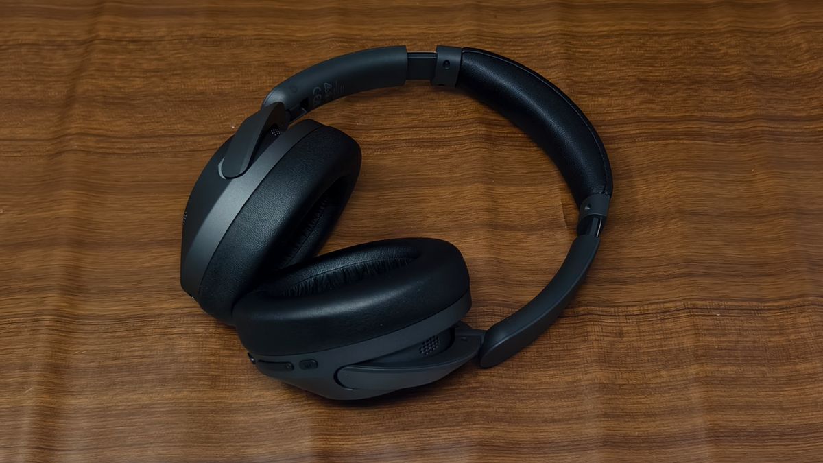 The Earfun Wave Pro on a wooden backdrop.