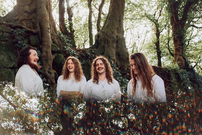 Wytch Hazel smiling and laughing in a forest