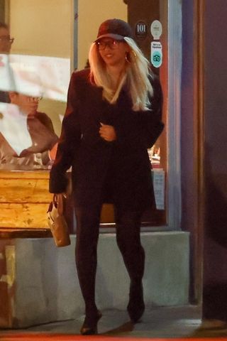 A photo of Beyoncé styling the no-pants trend with a black blazer and matching tights for a dinner date with Jay-Z.