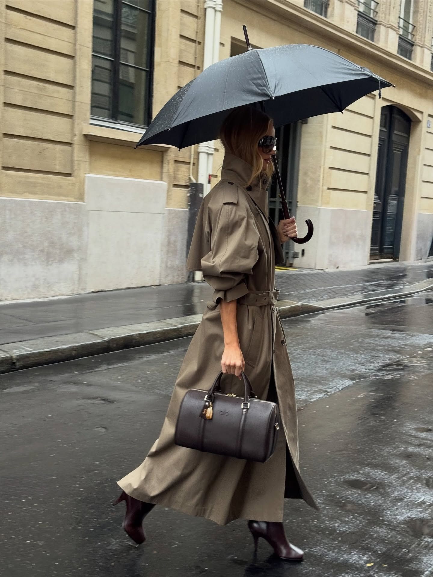 Rosie Huntington-Whiteley wearing a trench coat and burgundy boots.