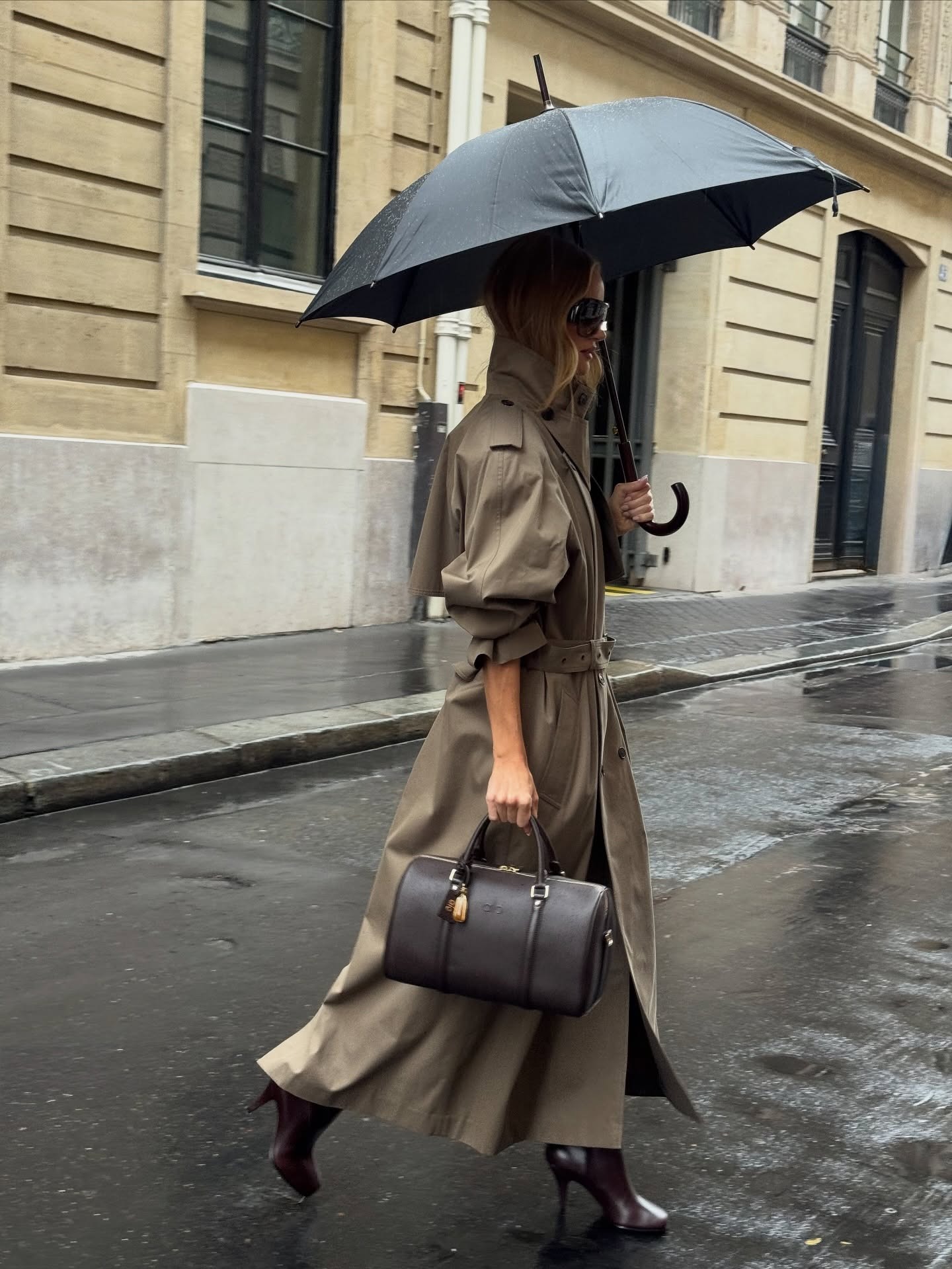 Rosie Huntington-Whiteley wearing a trench coat and burgundy boots.