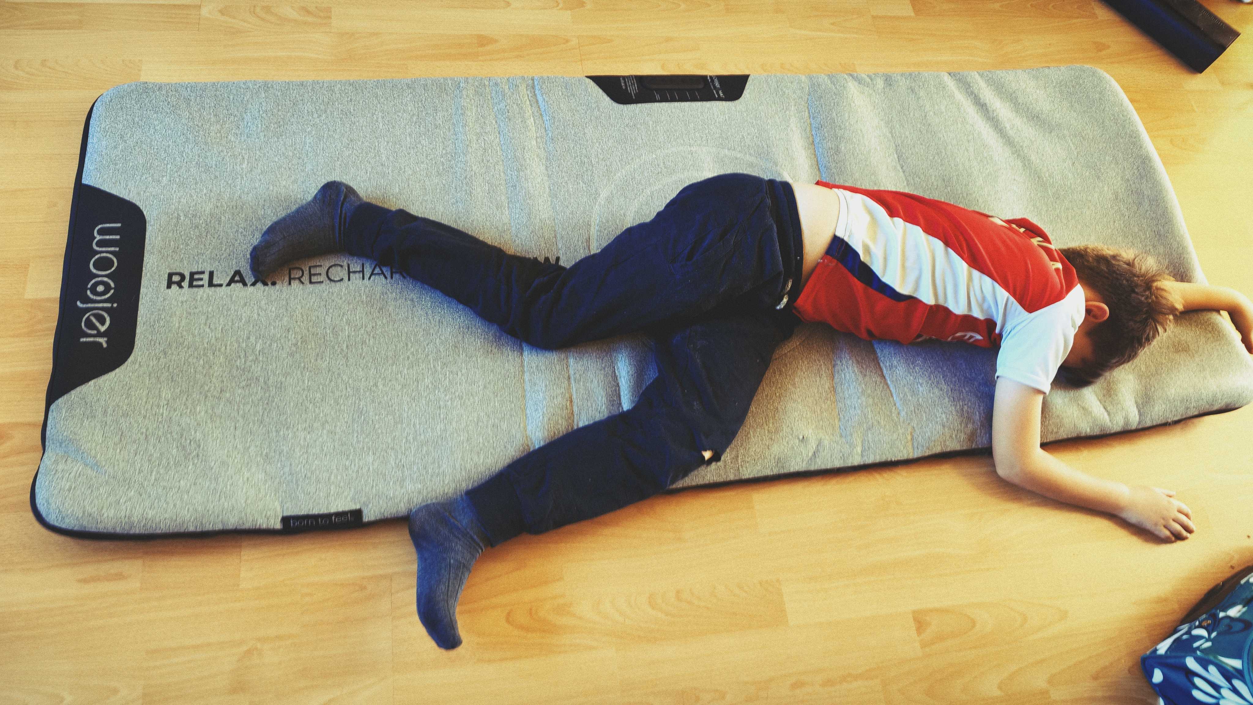 A Woojer Mat on a wooden floor