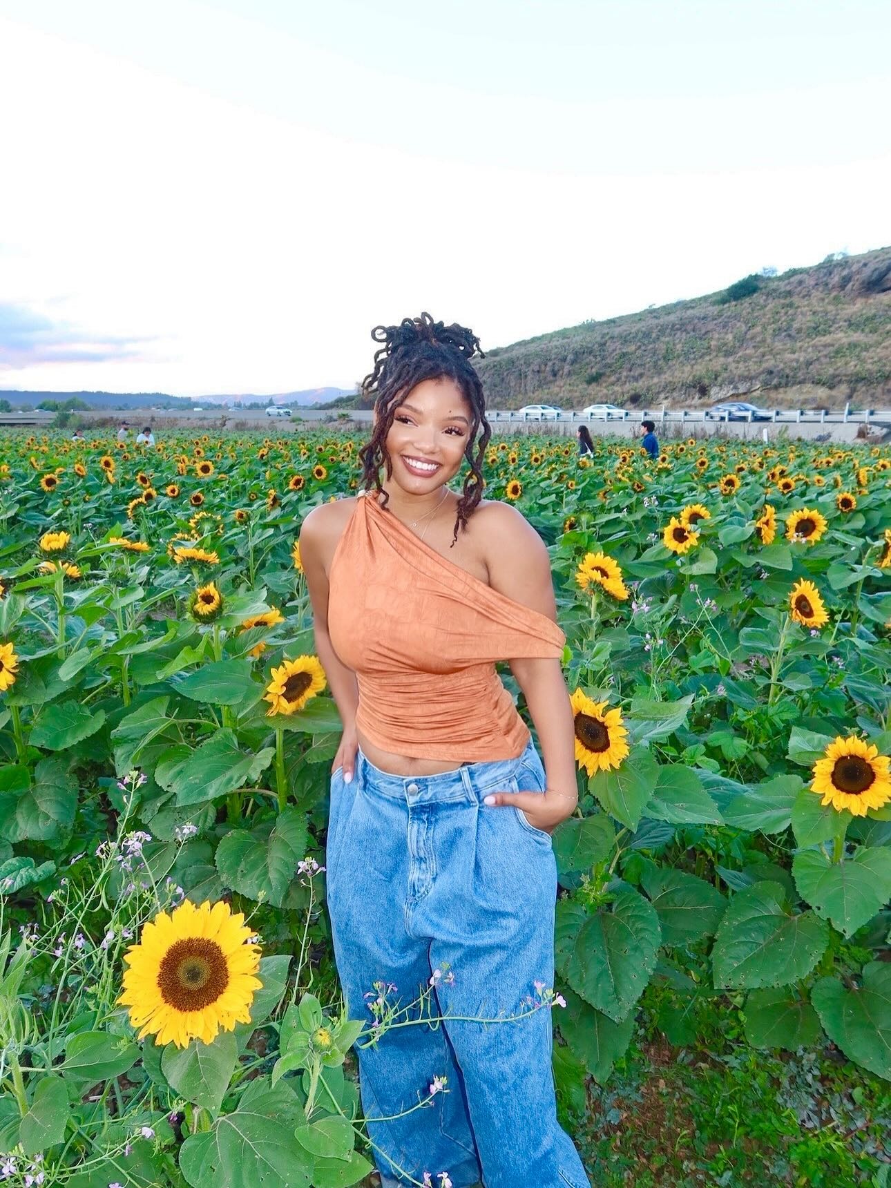 Halle Bailey wearing a messy loc&#039;d bun.