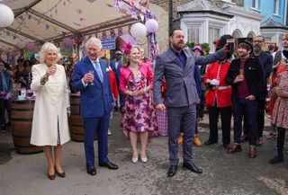 The Prince of Wales and The Duchess of Cornwall are welcomed by the Walford residents