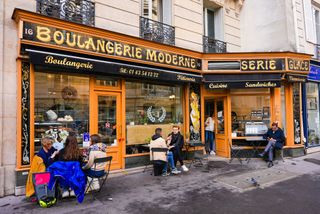 Patrons sit outside the SAS Boulangerie Moderne Rabineau in Paris