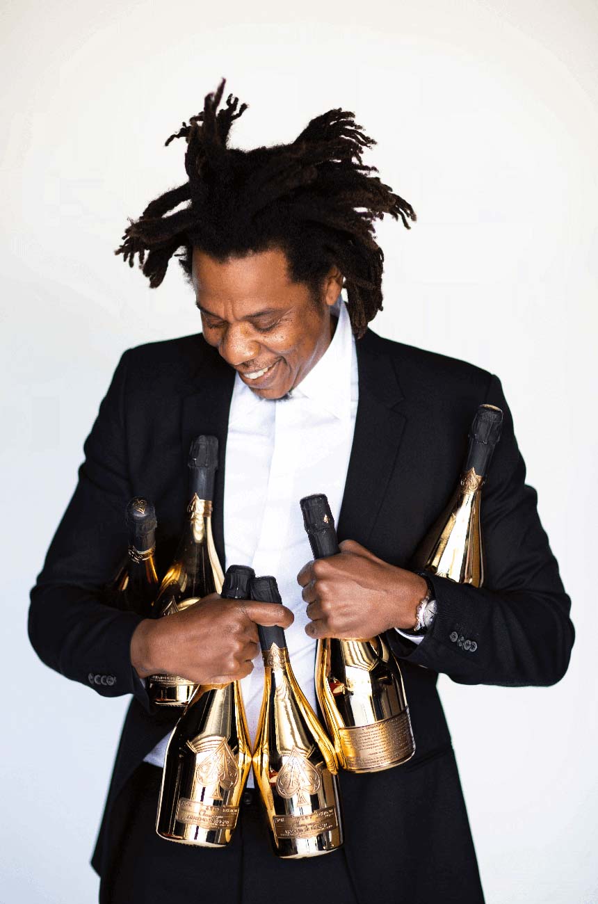 Jay-Z holding bottles of Armand de Brignac.