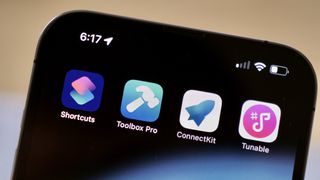 Photograph showing an iPhone with the icons for Toolbox Pro, ConnectKit, and Tunable (by AffinityBlue), the apps quoted by the developers in this article.