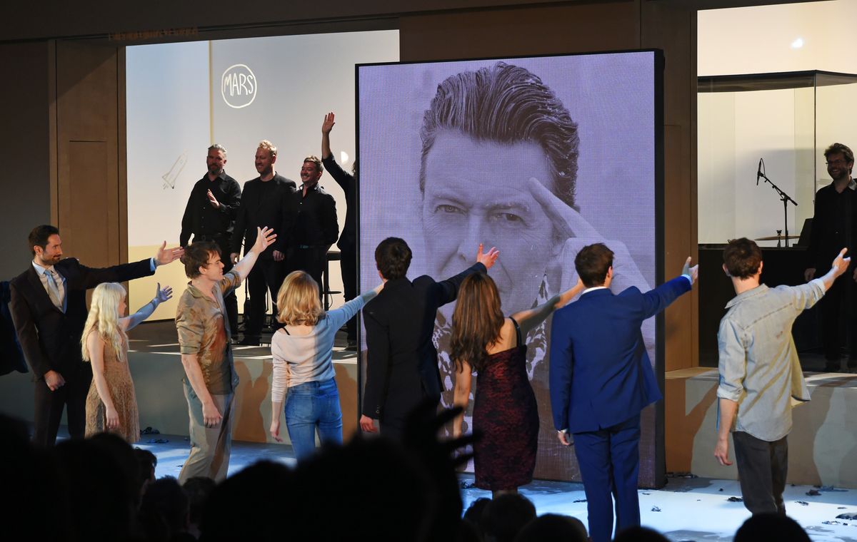 From left, cast members Tom Parsons, Sophia Anne Caruso, Michael C Hall, Amy Lennox, Michael Esper, Julie Yammanee and Jamie Muscato pay tribute to playwright David Bowie at the curtain call during the press night performance of &quot;Lazarus&quot; at the King&#039;s Cross Theatre on November 8, 2016, in London.