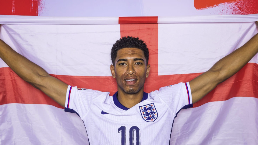 Jude Bellingham of England poses with the England flag ahead of England vs Serbia