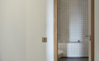 The apartment's bathrooms were also reworked using white tiling and grey Italian limestone