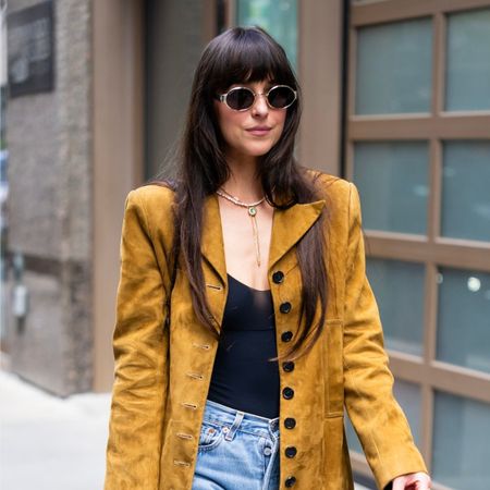 Dakota Johnson is seen in Midtown on May 30, 2025 in New York City, wearing jeans, a suede blazer and sunglasses
