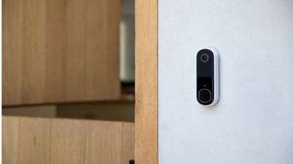 arlo video doorbell second generation installed next to wooden door