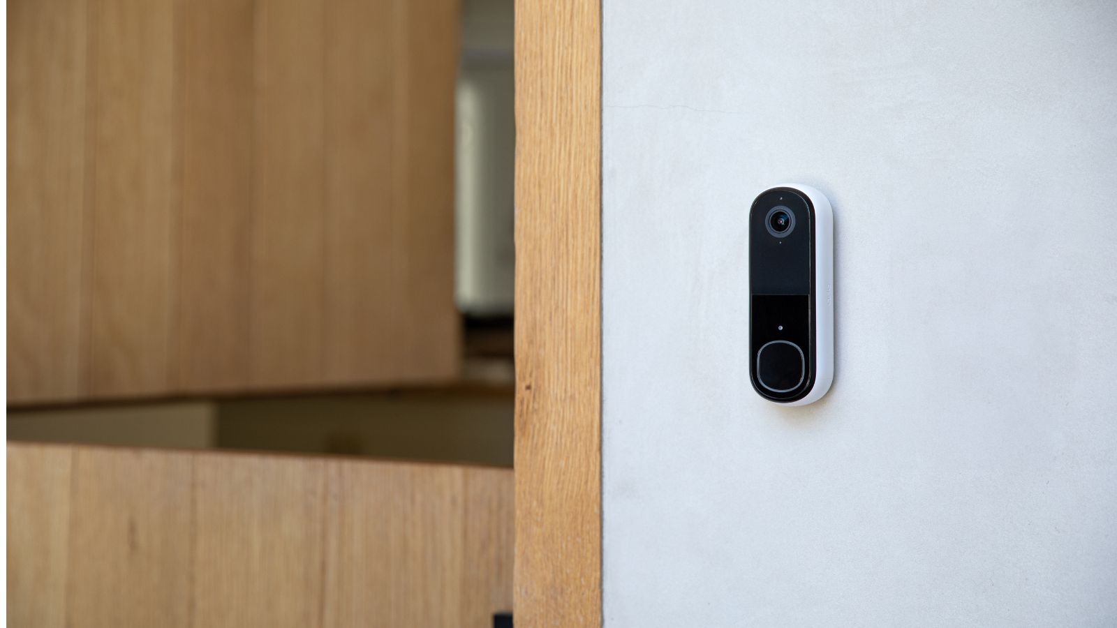 arlo video doorbell second generation installed next to wooden door