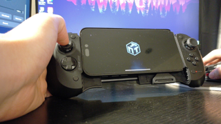 Scuf Nomad image of the controller being held on a desk by a reviewer