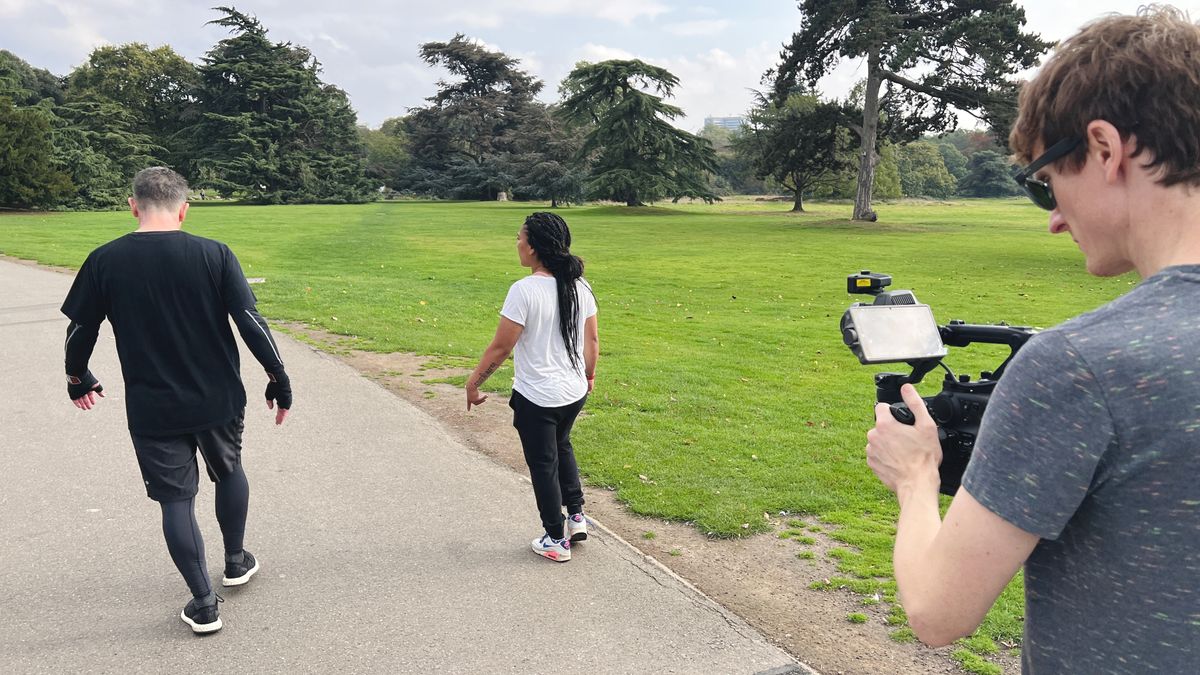 The DJI Ronin 4D being held by a filmmaker following two people
