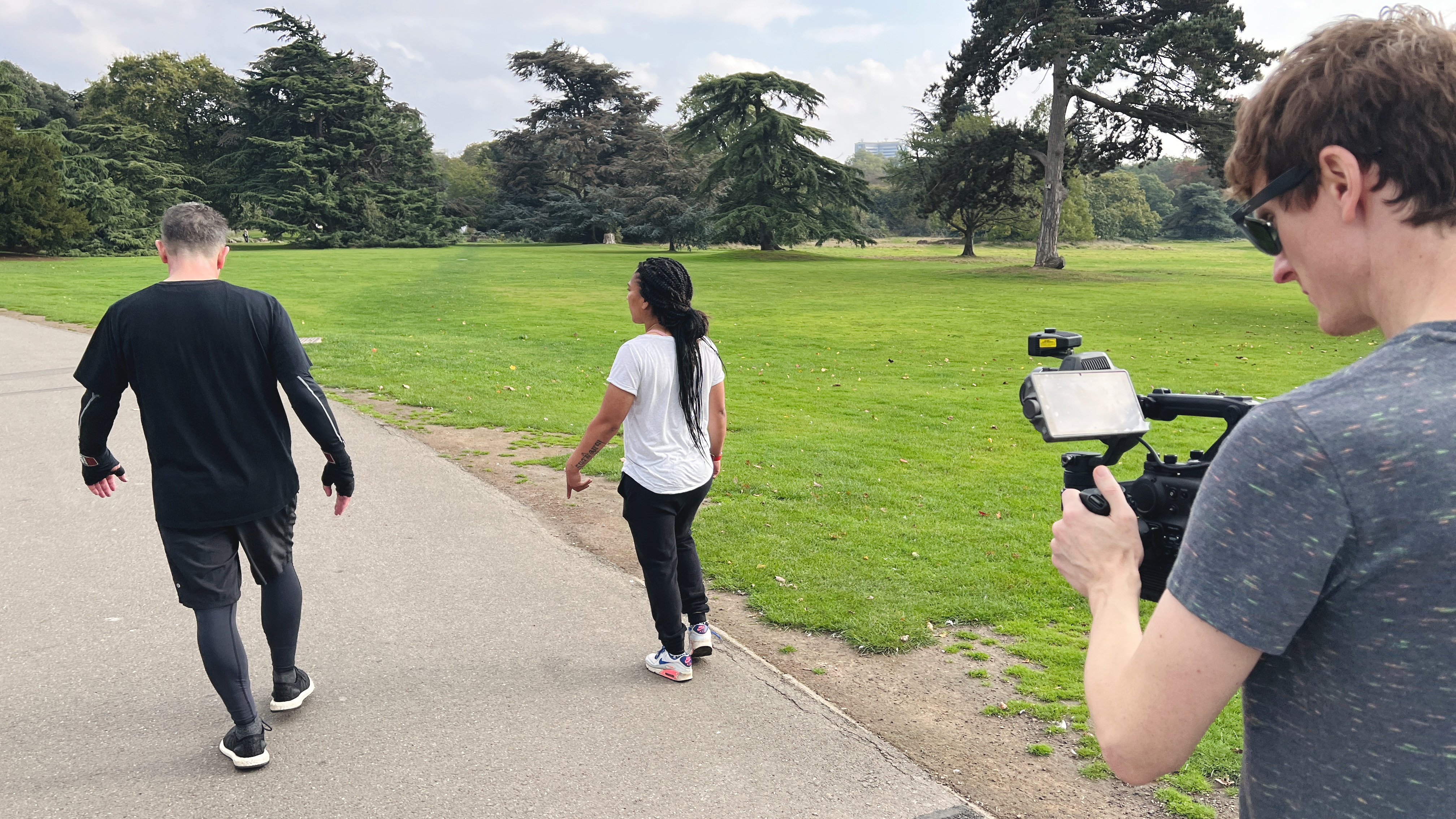 The DJI Ronin 4D being held by a filmmaker following two people