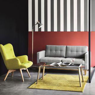 living room with arm chair and lamp with glass table