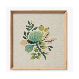 A blue floral bouquet wall art with a wooden frame