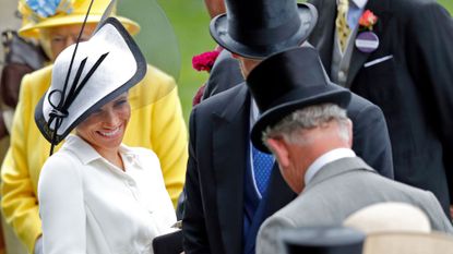 Meghan, Duchess of Sussex, laughs with King Charles at Day 1 of Royal Ascot in 2018