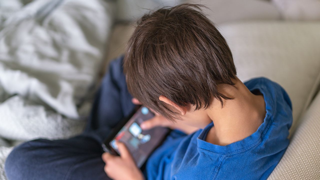 Child playing on mobile phone 