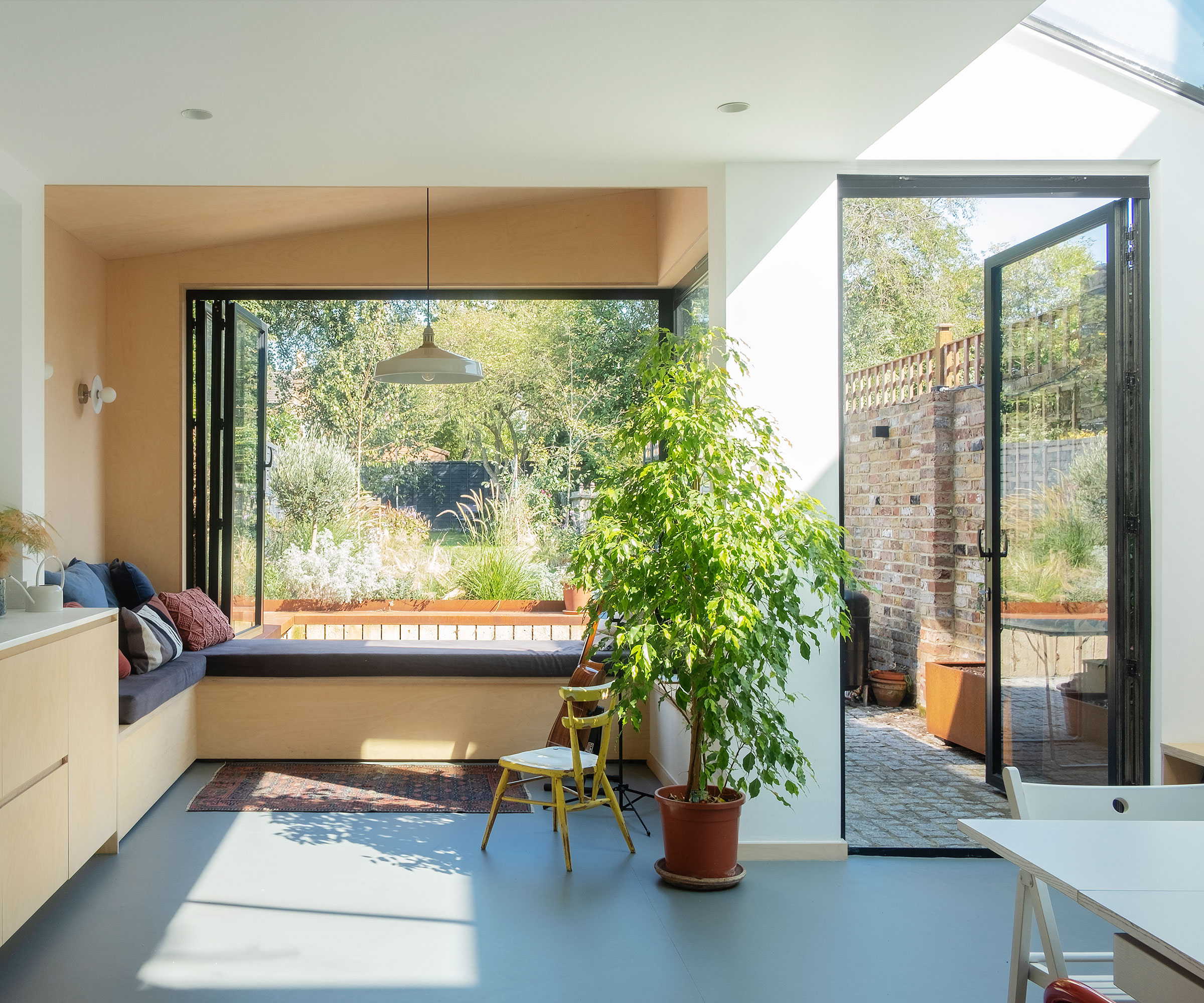 L-shaped extension with oriel window with window seat and bifold windows