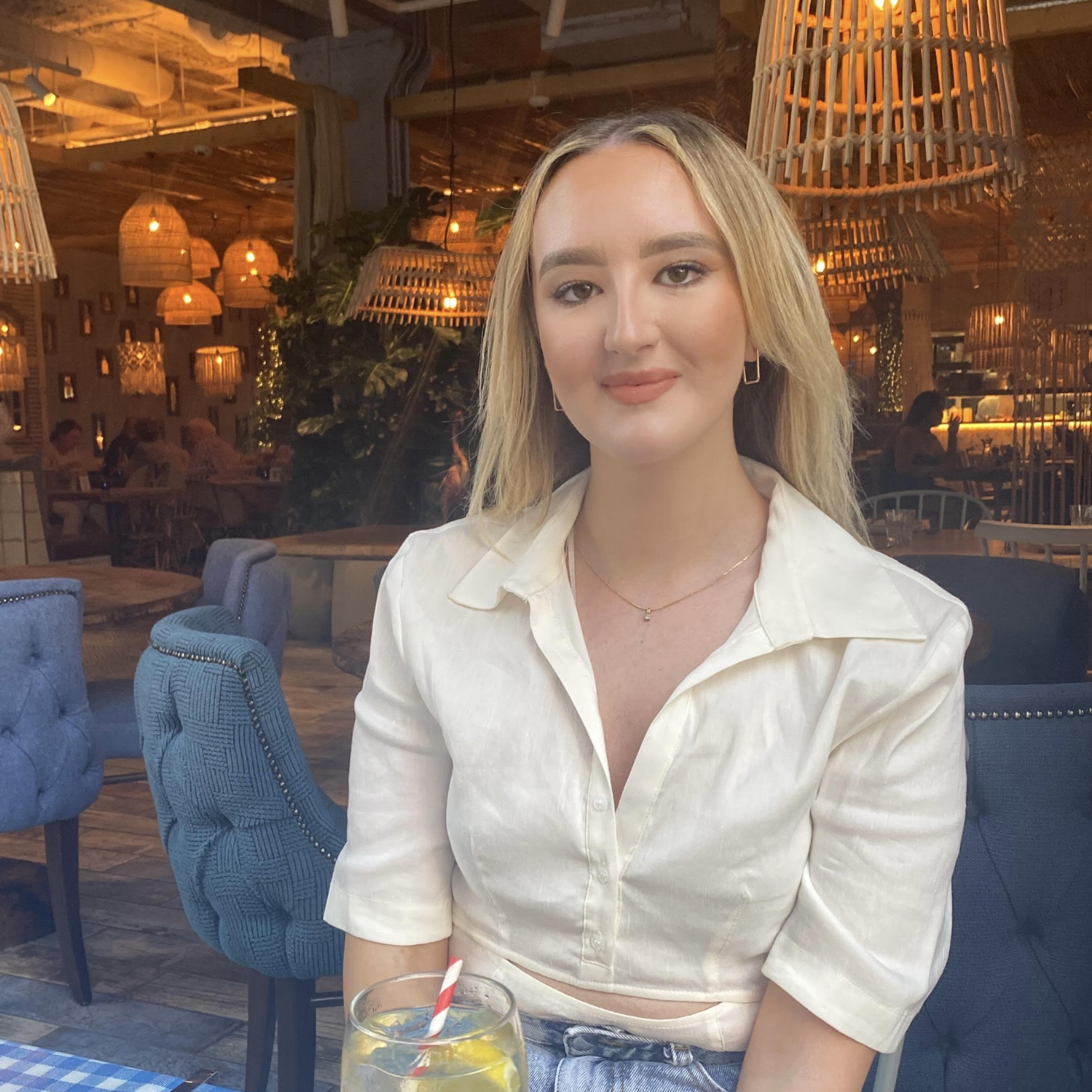 Louise Oliphant in a white shirt, sitting in a restaurant
